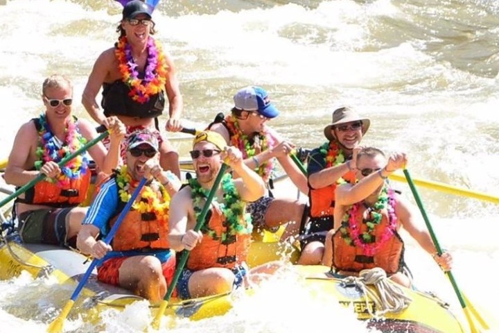 a group of people on a raft in a body of water