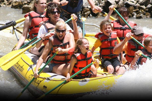 a group of people riding on the back of a boat