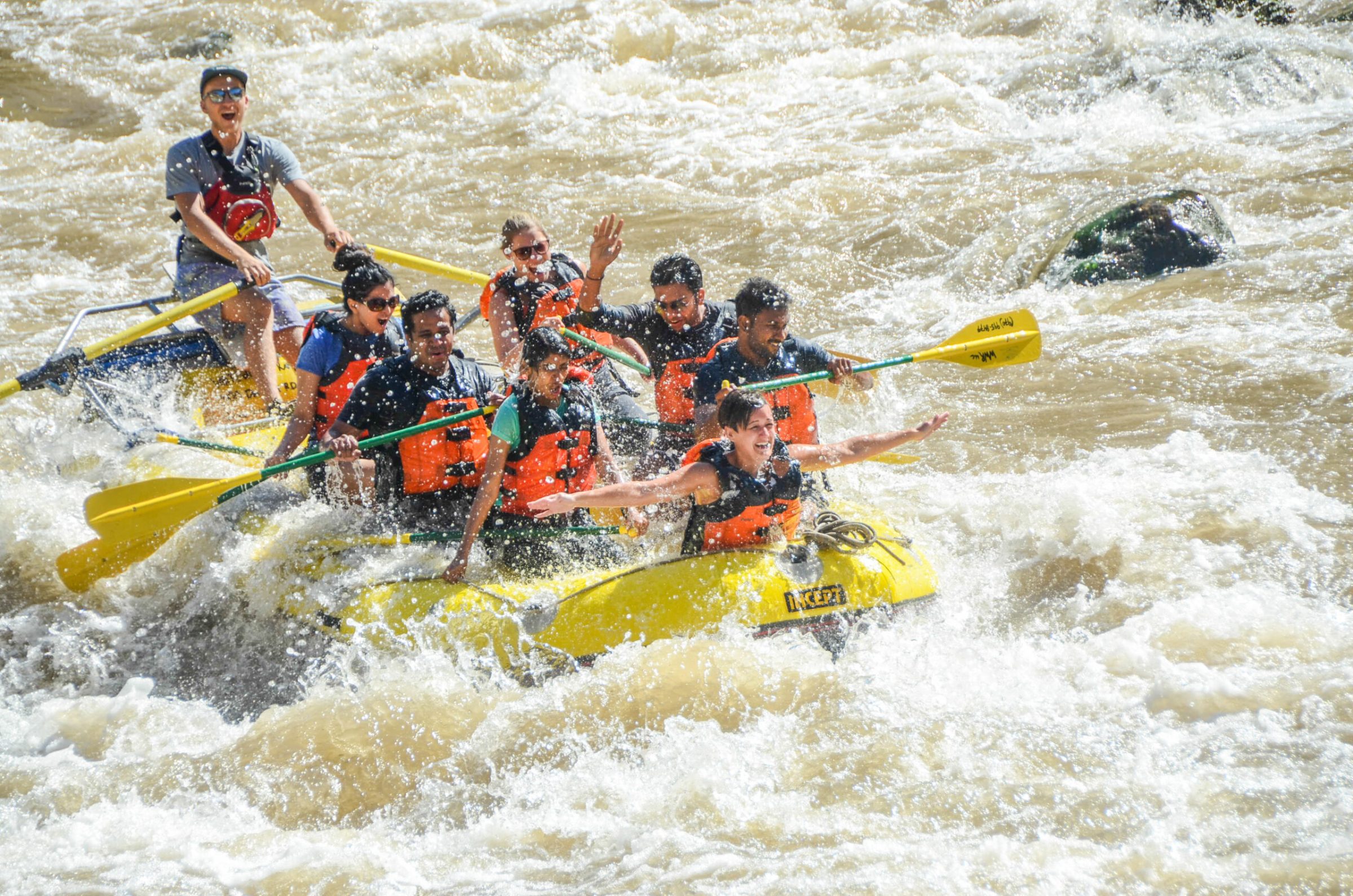 SH2_4859 a group of people riding skis on a raft in a body of water