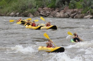 a group of people on a raft in a body of water