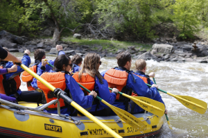 a group of people riding on the back of a boat