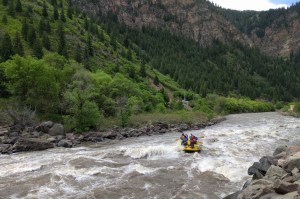 a man riding a motorcycle down a river