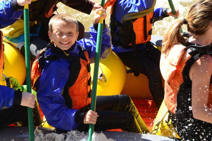 a group of people standing next to a child