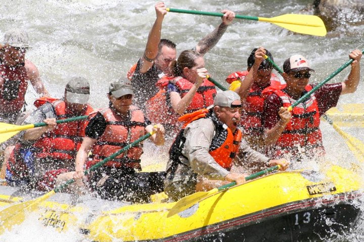 a group of people on a raft in a body of water