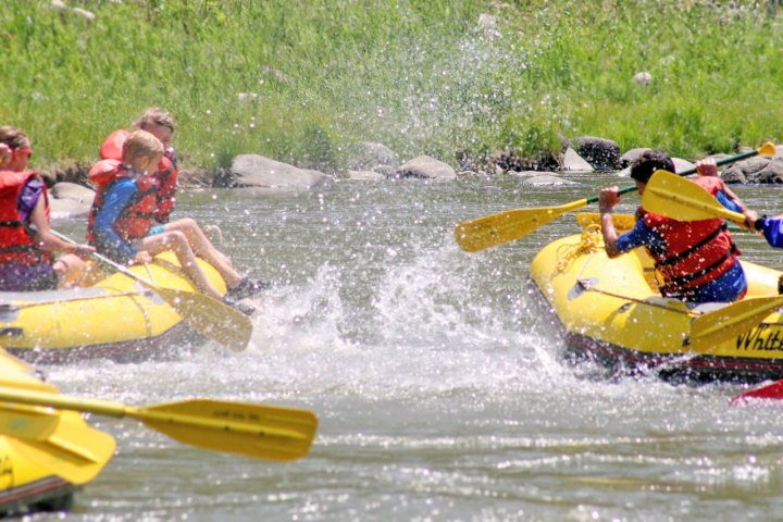a group of people riding on a raft
