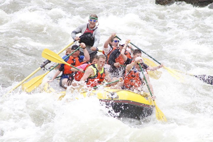 a group of people riding skis on a raft in a body of water