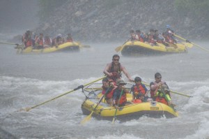 a group of people riding skis on a raft in a body of water