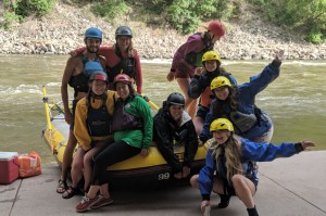 a group of people sitting on a boat in the water