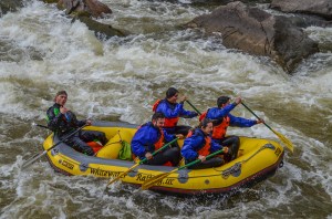 a group of people riding on a raft in a body of water