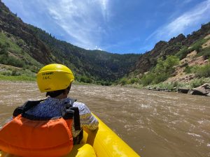 a man sitting on a raft in the water