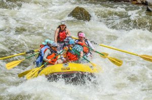 a man riding on a raft in a body of water